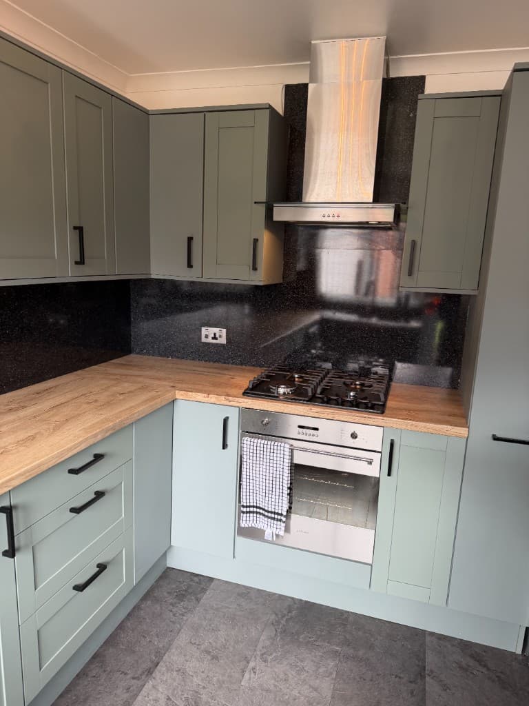 Wrapped kitchen with light wall units and tiled splashback